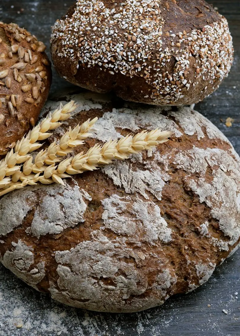 Loaves of wholegrain bread with wheat ears